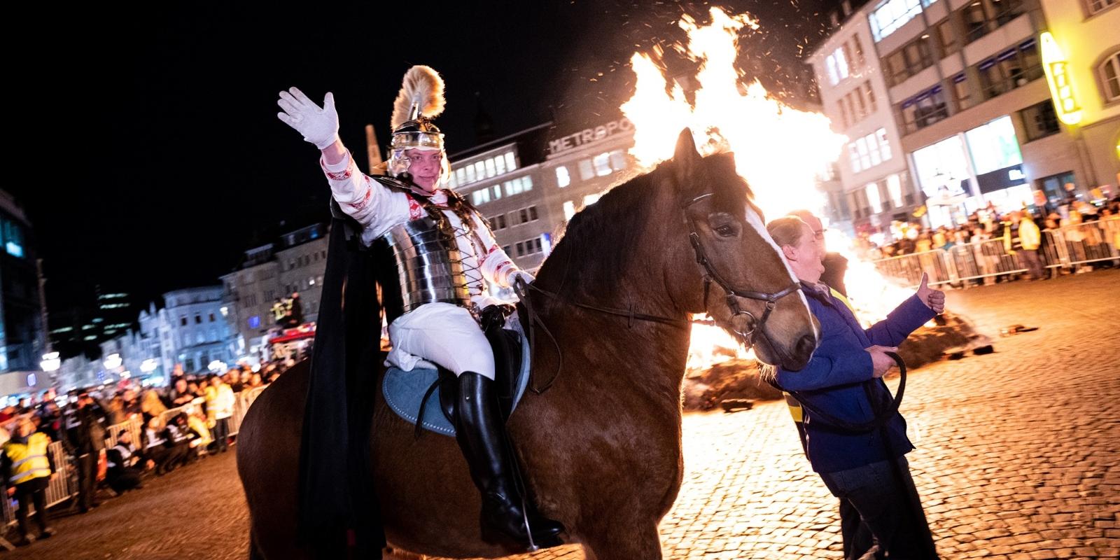 St. Martin wird am Martinsfeuer auf dem Bonner Marktplatz von Kindern und Jugendlichen empfangen.